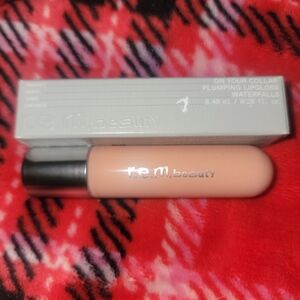 R.E.M. Beauty Plumping Lipgloss color: waterfalls brand new never used.